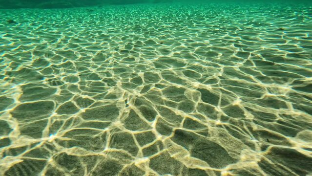 Mesmerizing underwater view of sand ripples caused by waves in Menorca