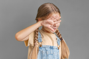 A little girl shows a sign of  protest with her hand
