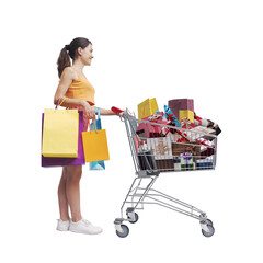 Happy woman pushing a shopping cart full of gifts