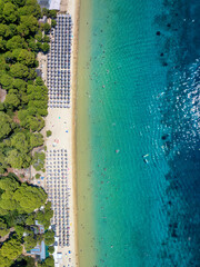 Aerial top down view of the popular Koukounaries beach with fine sand and emerald sea on Skiathos...