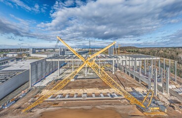 Drone image of a construction site of an industrial building with columns and beams and a...