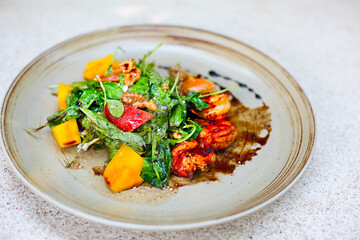 Delicious Seafood salad with vegetables and shrimps on the table
