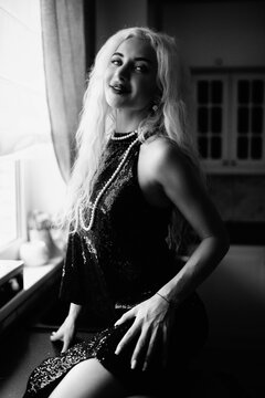 Portrait of a young beautiful blonde girl in vintage style. Black and white photo.