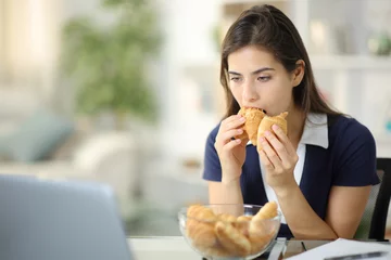 Raamstickers Discouraged anxious woman eating bakery © PheelingsMedia