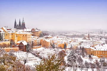 Zelfklevend Fotobehang Praag Snow in Prague, rare cold winter conditions. Prague Castle in Czech Republic, snowy weather with trees. City landscape from beautiful town. Winter travelling in Europe.
