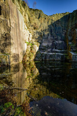 Fototapeta na wymiar rock wall with reflection in water