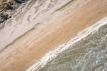 aerial overhead shot of sand beach with diagonal stripes