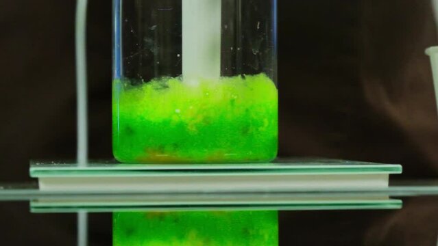 Combination of eggs and greens transforms gradually into smooth paste. Blending process observable through transparent walls of jug