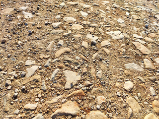 Texture and background of podzol soil with pebbles. Abstract Earth and stone as a place for text and copy space. Top view