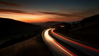 Cars red light trails at night in a curve asphalt road at night, long exposure image