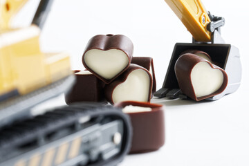 Toy excavator produces hearts - heart-shaped chocolates. Earning and receiving likes on social...
