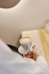 the waiter serves dishes and coffee on a tray