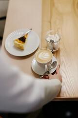 the waiter serves dishes and coffee on a tray