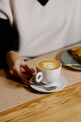 the waiter serves dishes and coffee on a tray