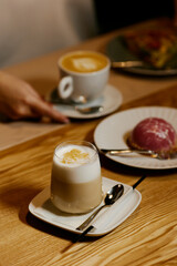 the waiter serves dishes and coffee on a tray