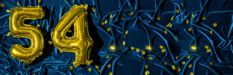 Gold foil balloon number number 54 on a background of blue velvet decoration. Birthday greeting...