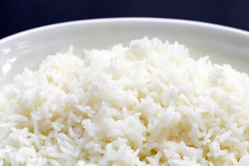 Cooked rice on dark background.