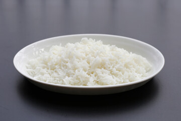 Cooked rice on dark background.