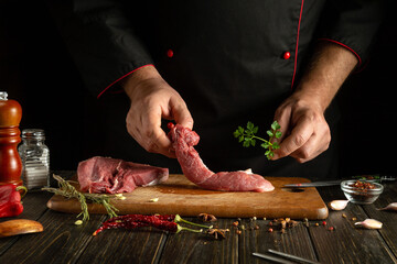 The chef is preparing aromatic lamb shish kebab on the kitchen table. The concept of cooking meat...