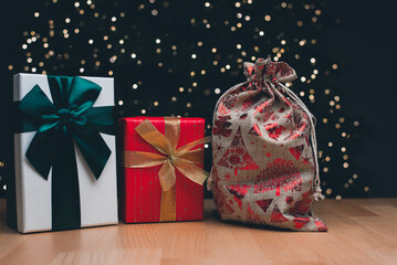 A gift box on the background of a Christmas tree. Happy New Year and Christmas.