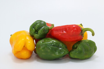 red, green and yellow paprikas isolated on white background