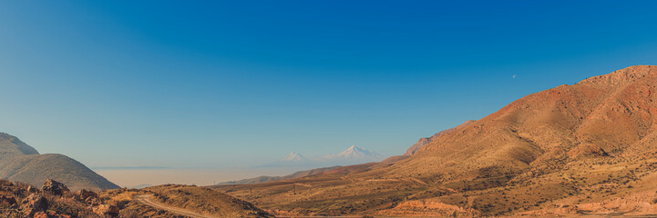 Fototapeta na wymiar Wide angle panoramic view of sunrise over the Ararat mountains. Travel destination Armenia