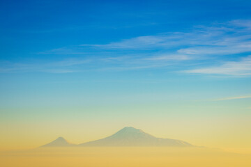 Colorful sunset over the Ararat mountains with mist over Ararat valley at winter as seen from...