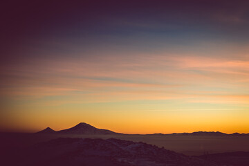 Colorful sunset over the Ararat mountains at winter as seen from the Aragats. Travel destination Armenia