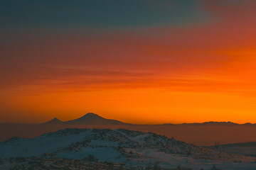 Red sunset over the Ararat mountains at winter as seen from the Aragats. Travel destination Armenia