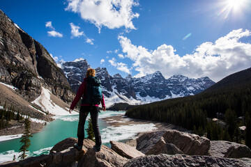 Naklejka premium Young woman in Moraine lake, Banff National Park, Canada