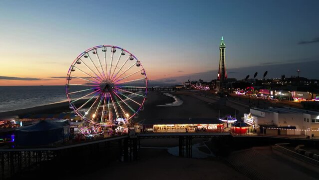 Central Pier and Blackpool tower at night, England, UK (aerial view)