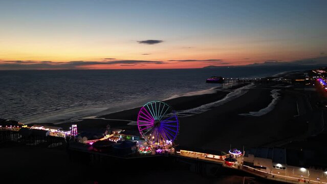 Night aerial shot of the piers and Blackpool tower, England, United Kingdom