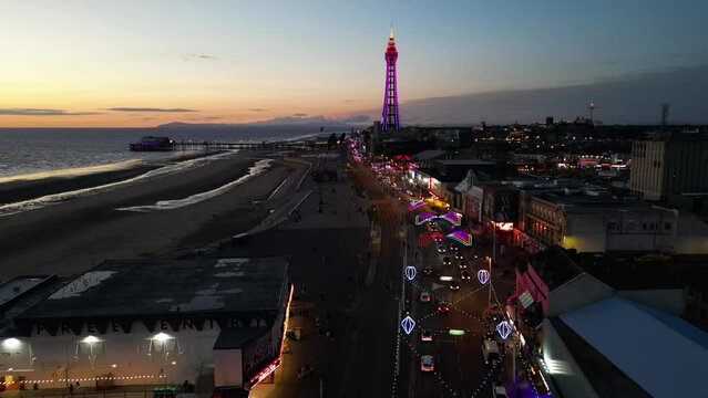 Night drone shot of a promenade and street in Blackpool city, England, UK