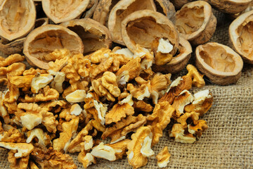 Walnuts on old rustic table. Walnut kernels and walnut shell. Vegetarian food.