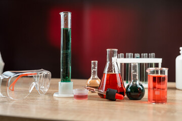 Group of laboratory flasks and beaker for experiment with color liquid in science laboratory
