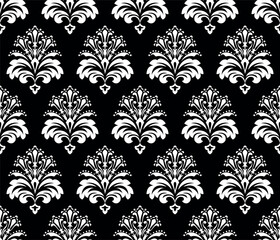 Wallpaper in the style of Baroque. Seamless vector background. White and black floral ornament. Graphic pattern for fabric, wallpaper, packaging. Ornate Damask flower ornament