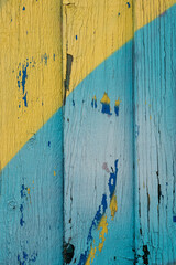 Close-up of blue and yellow painted wooden fence