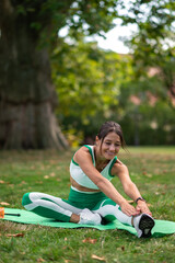 Dark-haired woman having workout in the park