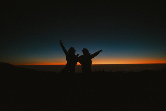 silhouette of young teens dancing in the sundown
