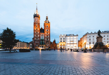 Cracow, Poland old town with St. Mary's Basilica and Adam Mickiewicz monument at the evening