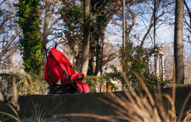 red buggy in a public park. photo during the day.