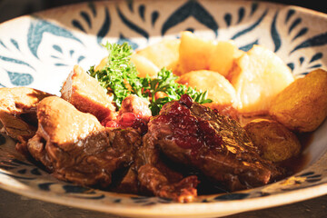 Roasted veal with potatoes and cranberries