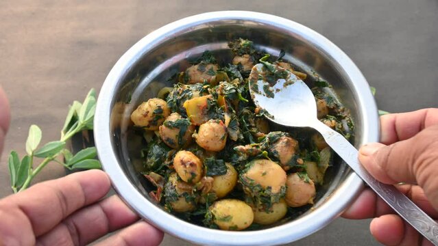 Aloo Methi or Fenugreek potato vegetable. It is made with fresh fenugreek leaves and potatoes. Indian homemade traditional Aalu Methi dry curry. Fenugreek potato sabzi  is healthy Indian Cuisine.