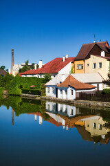 Fototapeta na wymiar Houses Reflecting in the Vajgar Pond in the Hamersky Potok River at Jindrichuv Hradec in the Czech Republic