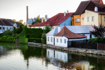 Fototapeta premium Houses Reflecting in the Vajgar Pond in the Hamersky Potok River at Jindrichuv Hradec in the Czech Republic