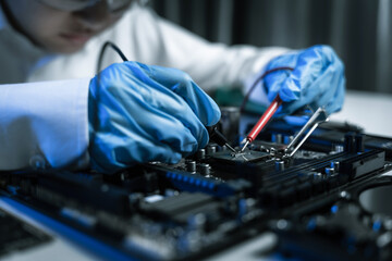 Hands repairing electronic devices. Electronic technician.