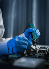 Hands repairing electronic devices. Electronic technician.