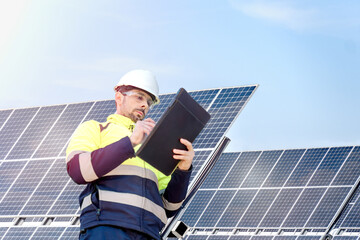 Attractive engineer installing solar panels and clean energy