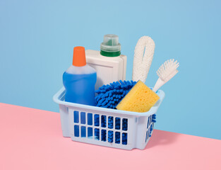 The blue basket with cleaning products. House cleaning concept.