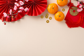 Obraz premium CNY traditional decorations. Top view of hanging knot, vibrant red fans, money envelopes, fortune coins, tangerines, flowers on festive, auspicious background with space for greetings or event details